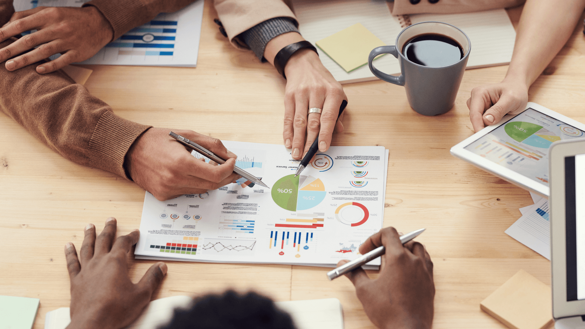 Team analysing property investment charts and financial data during a strategy session