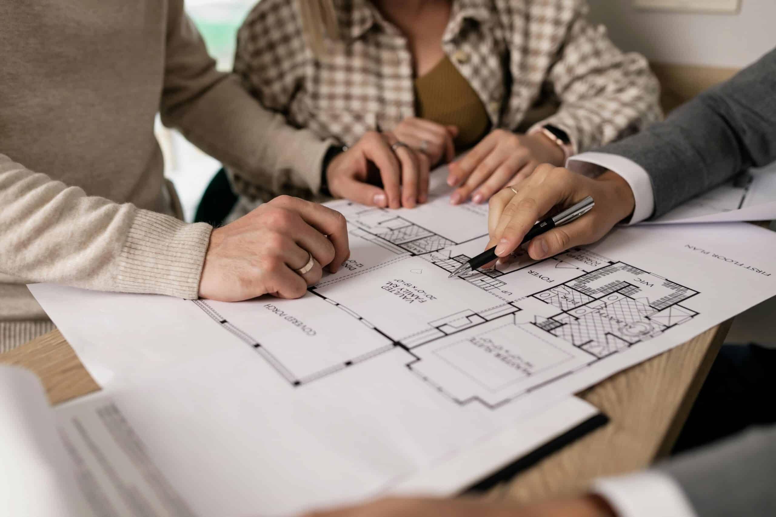 Investors reviewing floor plan with a property advisor